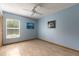 Bright bedroom features a ceiling fan, tiled floor, and a window providing natural light at 812 Silverwood Dr, Lake Mary, FL 32746