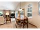 Inviting dining area next to fireplace with a view to a screened-in pool at 812 Silverwood Dr, Lake Mary, FL 32746