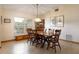 Cozy dining area with a wooden table set, chandelier, and a large window at 812 Silverwood Dr, Lake Mary, FL 32746