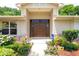 Elegant front entrance with double doors, decorative plants, and inviting pathway at 812 Silverwood Dr, Lake Mary, FL 32746