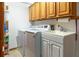 Functional laundry room featuring a washer, dryer, utility sink, and ample storage at 812 Silverwood Dr, Lake Mary, FL 32746