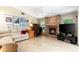 Cozy living room with brick fireplace, large TV, and desk for remote work at 812 Silverwood Dr, Lake Mary, FL 32746