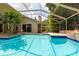 Private pool with screened enclosure is surrounded by lush landscaping for a tropical feel at 812 Silverwood Dr, Lake Mary, FL 32746