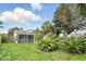 Spacious backyard featuring a screened-in patio, tropical foliage, and a well-maintained lawn at 826 Bright Meadow Dr, Lake Mary, FL 32746