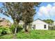 Well-maintained backyard with lush lawn, mature trees, and partial view of screened-in patio at 826 Bright Meadow Dr, Lake Mary, FL 32746