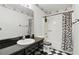 Full bathroom with a shower and bathtub combo, a zebra print curtain, and black and white tiled flooring at 826 Bright Meadow Dr, Lake Mary, FL 32746