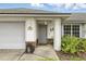 Close-up of front porch with decorative address plaque, door decor, and lush green fern at 826 Bright Meadow Dr, Lake Mary, FL 32746