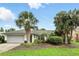 Charming single-story home with a well-manicured lawn, mature palm trees, and a two-car garage at 826 Bright Meadow Dr, Lake Mary, FL 32746