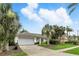 Attractive single-story home featuring mature palm trees, green lawn, and convenient two-car garage at 826 Bright Meadow Dr, Lake Mary, FL 32746