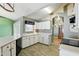 Updated eat-in kitchen offers white cabinets and countertops with a view to the formal living area at 826 Bright Meadow Dr, Lake Mary, FL 32746