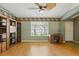 Inviting living room showcasing laminated wood floors, natural light, and a unique ceiling fan at 826 Bright Meadow Dr, Lake Mary, FL 32746