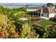 A beautifully landscaped backyard featuring a patio and a view of the lake at 871 Iron Oak Way, The Villages, FL 32163