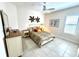 Inviting bedroom with tile flooring, natural light, and calming decor at 871 Iron Oak Way, The Villages, FL 32163