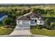 Well-maintained home featuring a three-car garage and a manicured lawn at 871 Iron Oak Way, The Villages, FL 32163