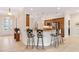 Open kitchen with granite countertops and bar seating with decorative chairs at 871 Iron Oak Way, The Villages, FL 32163