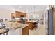 Spacious kitchen featuring an island with barstool seating and stainless steel appliances at 871 Iron Oak Way, The Villages, FL 32163
