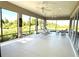 Large covered lanai with ample seating and stunning views of lush greenery at 871 Iron Oak Way, The Villages, FL 32163