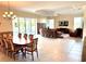 Open-concept living and dining room featuring a large dining table and comfortable seating at 871 Iron Oak Way, The Villages, FL 32163