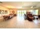 Spacious living room and dining room featuring tiled floors and sliding glass doors at 871 Iron Oak Way, The Villages, FL 32163