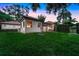 The backyard has green grass and a partial view of the screened-in back patio at 914 Sweetgum Valley Pl, Lake Mary, FL 32746