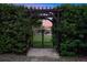 This backyard entrance has an arbor, an iron gate, and a view of the house at 914 Sweetgum Valley Pl, Lake Mary, FL 32746