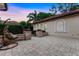 Backyard patio area featuring a hanging chair and low stone wall with planters at 914 Sweetgum Valley Pl, Lake Mary, FL 32746