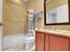 Bathroom featuring granite counters, tile floors, and a shower and tub combo at 914 Sweetgum Valley Pl, Lake Mary, FL 32746