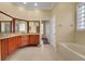 Well-lit bathroom showcasing double vanities, granite countertops, and a separate soaking tub at 914 Sweetgum Valley Pl, Lake Mary, FL 32746