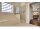 Elegant bathroom featuring a glass-enclosed shower, soaking tub, and stylish tile accents at 914 Sweetgum Valley Pl, Lake Mary, FL 32746