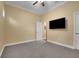 Bedroom with carpet, neutral walls, a ceiling fan, and a mounted television for entertainment at 914 Sweetgum Valley Pl, Lake Mary, FL 32746