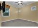Neutral bedroom featuring carpet floors, ceiling fan, and window views at 914 Sweetgum Valley Pl, Lake Mary, FL 32746