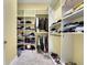 Walk-in closet with custom shelving and organization, providing ample storage space for clothes and accessories at 914 Sweetgum Valley Pl, Lake Mary, FL 32746