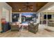 This covered patio has nice furniture, a ceiling fan, and a view of the beautiful pool at 914 Sweetgum Valley Pl, Lake Mary, FL 32746