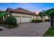 Home exterior with a three car garage and brick paved driveway at 914 Sweetgum Valley Pl, Lake Mary, FL 32746