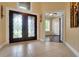 Inviting foyer with tile flooring and decorative glass double doors at 914 Sweetgum Valley Pl, Lake Mary, FL 32746
