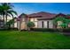 Charming two-story home with tile roof, stone accents, manicured lawn, and beautiful landscaping at 914 Sweetgum Valley Pl, Lake Mary, FL 32746