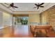 Bright game room with hardwood floors, a beautiful pool table, and access to the outdoor patio at 914 Sweetgum Valley Pl, Lake Mary, FL 32746