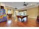 Spacious game room features hardwood floors, pool table, arcade game, and access to the outdoor living area at 914 Sweetgum Valley Pl, Lake Mary, FL 32746