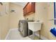 Laundry room featuring a utility sink, tiled floors, and upper cabinets at 914 Sweetgum Valley Pl, Lake Mary, FL 32746