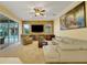Spacious living room featuring stone accent wall, modern furnishings, and access to outdoor pool area at 914 Sweetgum Valley Pl, Lake Mary, FL 32746