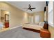 Main bedroom with carpet floors, a ceiling fan, and ensuite bathroom access at 914 Sweetgum Valley Pl, Lake Mary, FL 32746