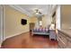 Spacious main bedroom featuring tray ceilings, hardwood floors, and ample natural light at 914 Sweetgum Valley Pl, Lake Mary, FL 32746