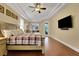 Bright main bedroom with tray ceilings, hardwood floors, and a private access to the backyard at 914 Sweetgum Valley Pl, Lake Mary, FL 32746