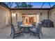 This outdoor patio has a table, 4 chairs, and a view of the house through the sliding doors at 914 Sweetgum Valley Pl, Lake Mary, FL 32746