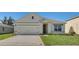 Charming single-Gathering home with a well-maintained lawn and a two-car garage at 935 Princess Sabal Pt, Haines City, FL 33844