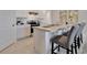 Kitchen boasts white cabinets, stainless steel appliances, and a practical center island with seating at 939 Princess Sabal Pt, Haines City, FL 33844