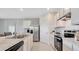 Kitchen boasts white cabinets, stainless steel appliances, and a practical center island at 939 Princess Sabal Pt, Haines City, FL 33844
