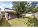 Backyard of the home features a tree, grass, and a screened-in patio at 9567 Meadow Hunt Way, Winter Garden, FL 34787
