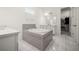 Bright bathroom with a large soaking tub, gray tile surround, white cabinets and a walk-in closet at 9567 Meadow Hunt Way, Winter Garden, FL 34787