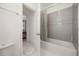 Bright bathroom showcases a shower with tile, a shower curtain, and white fixtures at 9567 Meadow Hunt Way, Winter Garden, FL 34787